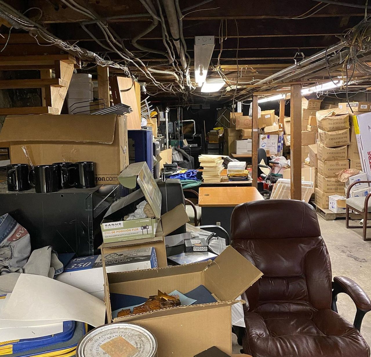 Before: basement packed with furniture, boxes and appliances in Cicero NY