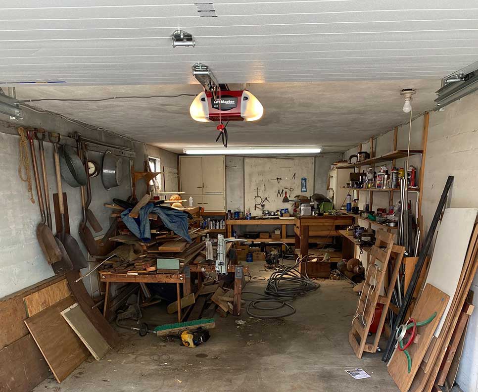 Before: garage full of tools, tires and scrap wood in Liverpool NY